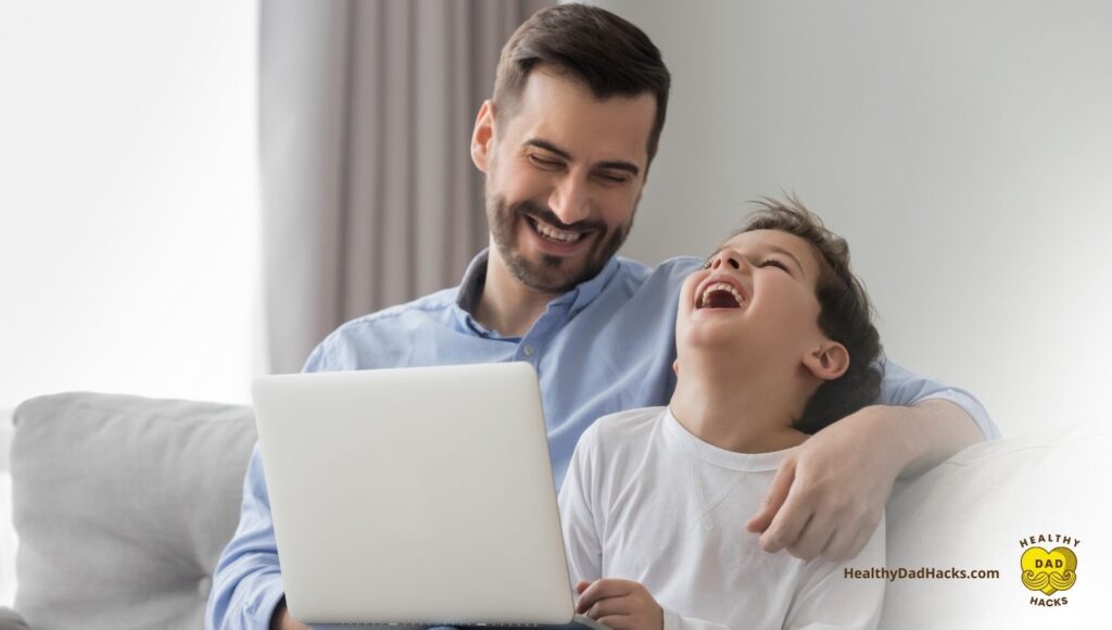 Dad son laughing as they create an SOP on laptop together