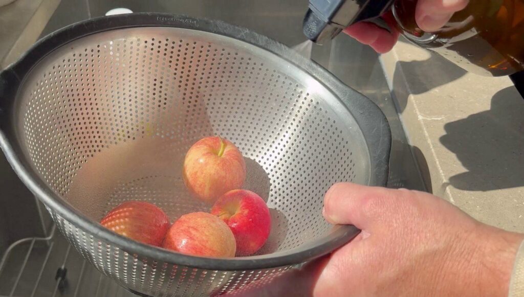 Best Organic Fruit and Veggie Wash - Fit Organic - Spraying apples