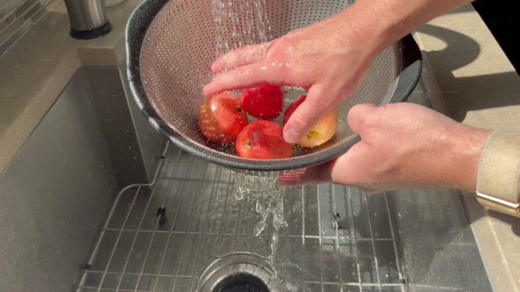 Best Organic Fruit and Veggie Wash - Fit Organic - Rinsing in colander 