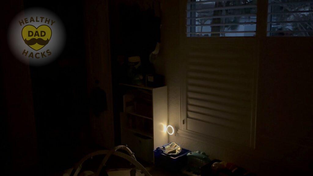 The nightlight of the Calm Me Sound Machine in dark nursery