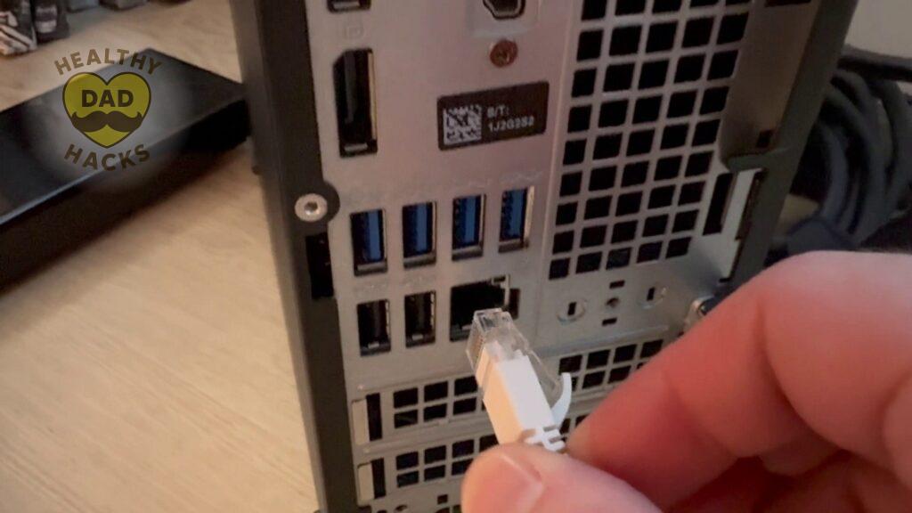 Ethernet cable being plugged into the back of a Refurbished Desktop Dell PC Computer - Optiplex 7060