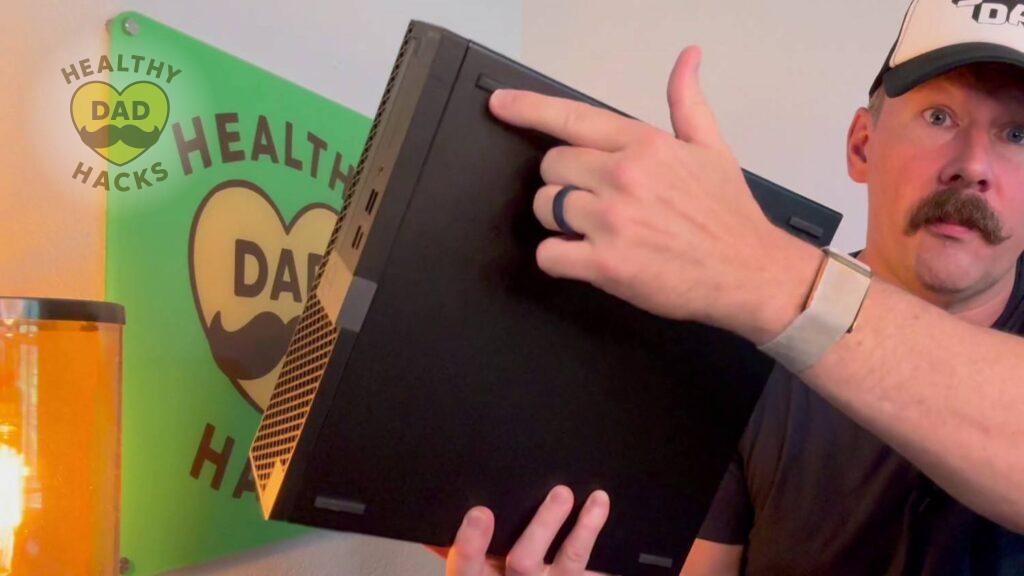 Dad points at the rubber feet of the Refurbished Desktop Dell PC Computer Optiplex 7060