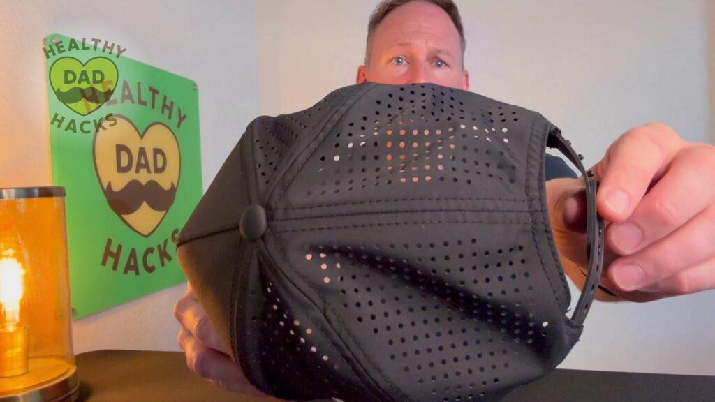 Review Dad holds Branded Bills hat showing ventilated top with holes