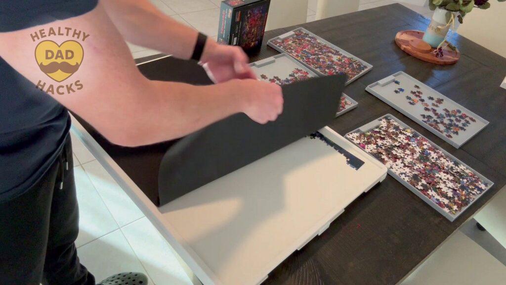 Placing protective mat over top of puzzle